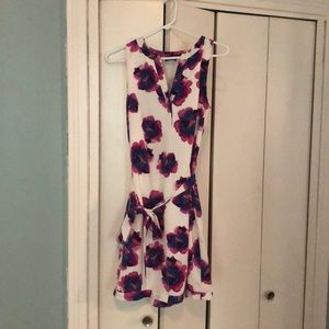 White satin-like dress with pink flower pattern.